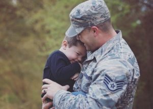 husband hugging child before deployment
