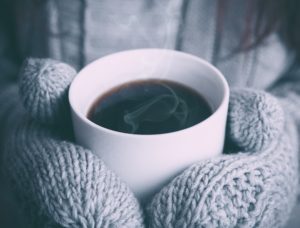 winter gloves around hot drink