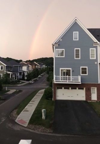 rainbow above house in neighborhood