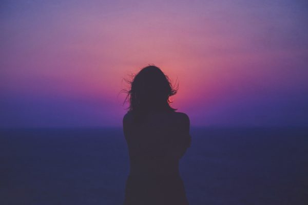woman alone with purple night sky