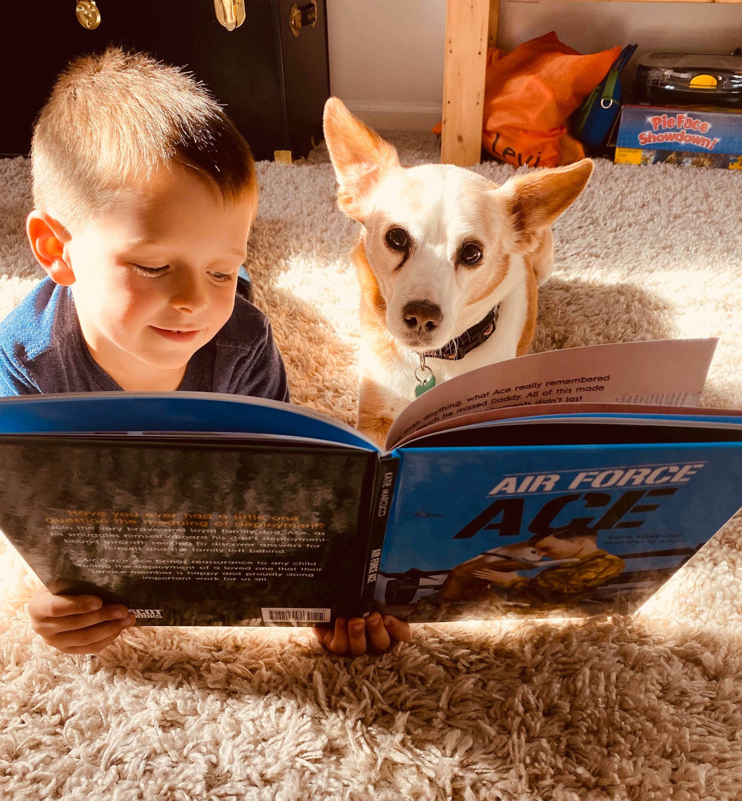 boy and dog reading Air Force Ace