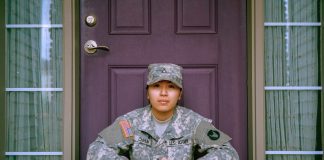 American soldier sitting on doorstep