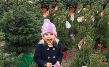 Girl smiling and excited in Christmas Tree lot