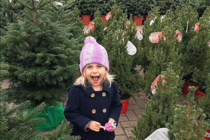Girl smiling and excited in Christmas Tree lot