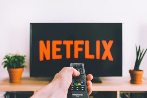 hand on remote for Netflix