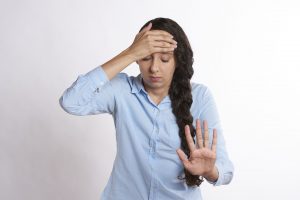 overwhelmed woman with hand up