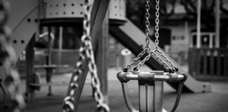 playground swings in black and white