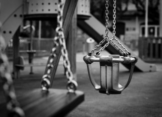 playground swings in black and white