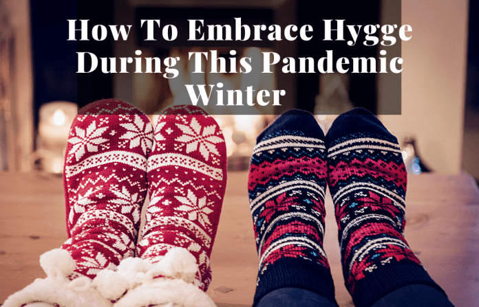 cozy socked feet by fireplace to show hygge