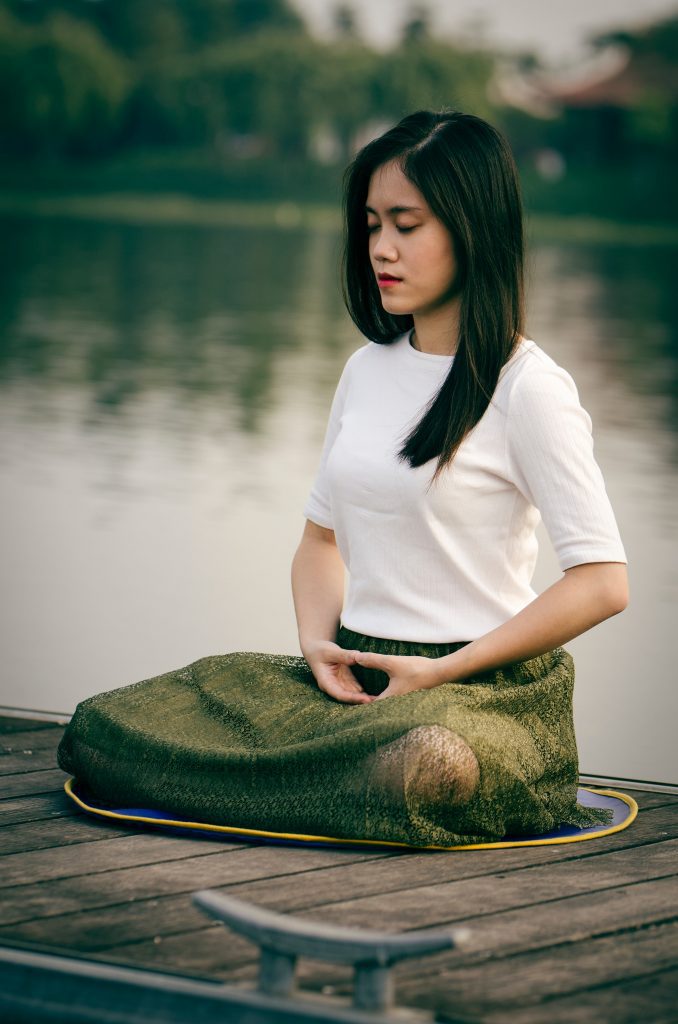 woman sitting on dock breathing