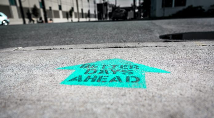 positive arrow on road that reads better days ahead