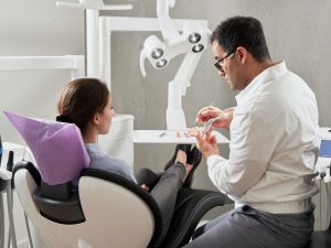 dentist consulting with a patient in a chair