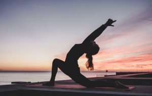 Yoga pose at sunrise on beach