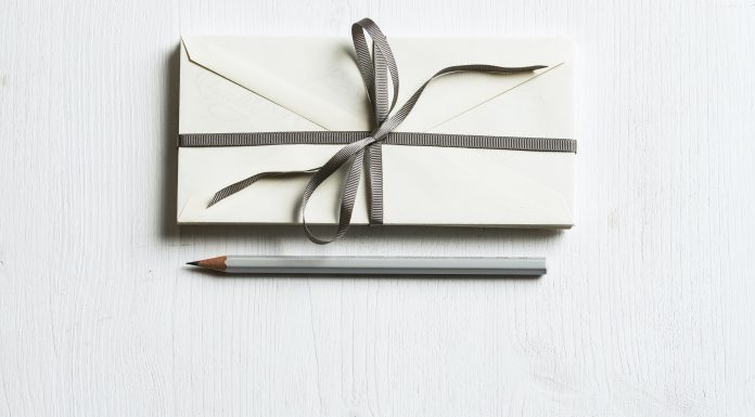 a gift with a bow and a pencil next to it