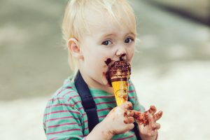 child eating a messy ice cream cone snack
