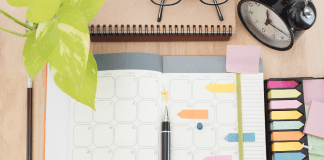 desktop with planner and notes and pens