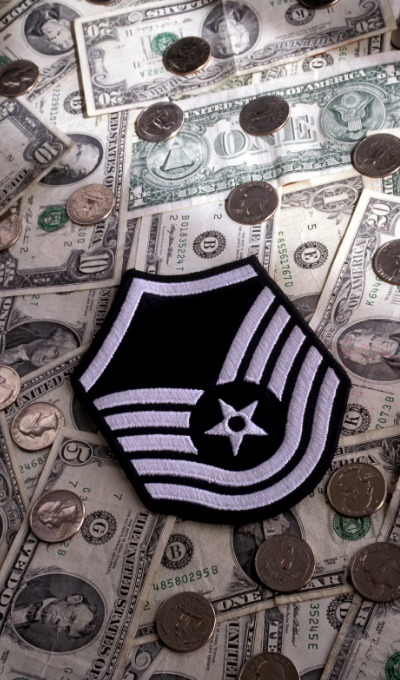 military rank badge on pile of money
