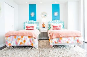twin beds decorated in bright colors