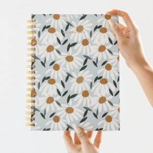 Golden Coil is a fully custom planner that every mom will love! This planner is baby blue with artful daisies, but so many more designs are available!