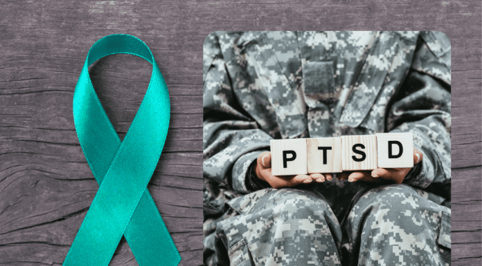 teal ribbon on wood grain background with a soldier holding blocks spelling PTSD