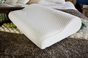 Tempur-Pedic Neck pillow sits on bed (for Friday Favorites)