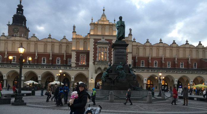 Mother and children standing in the main square of Krakow, Poland 2016