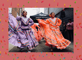 Hispanic dancers in traditional dress with a pale coral background and confetti