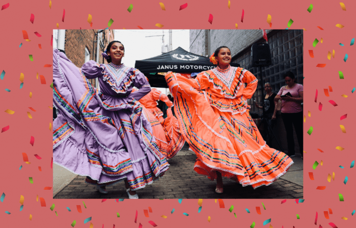 Hispanic dancers in traditional dress with a pale coral background and confetti