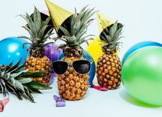 pineapples wearing sunglasses and beach balls