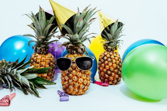 pineapples wearing sunglasses and beach balls