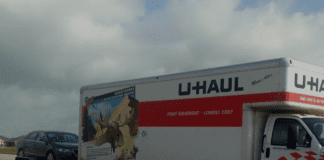 U-Haul truck towing a car and "Moving with Cars During a PCS" in text