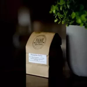 Palate coffee bag on a table with a plant