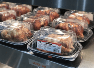 Costco rotisserie chickens in packaging under a warmer