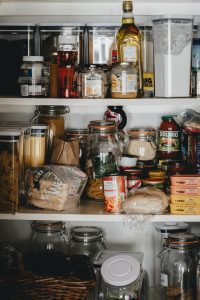 unorganized cabinet or pantry filled with items