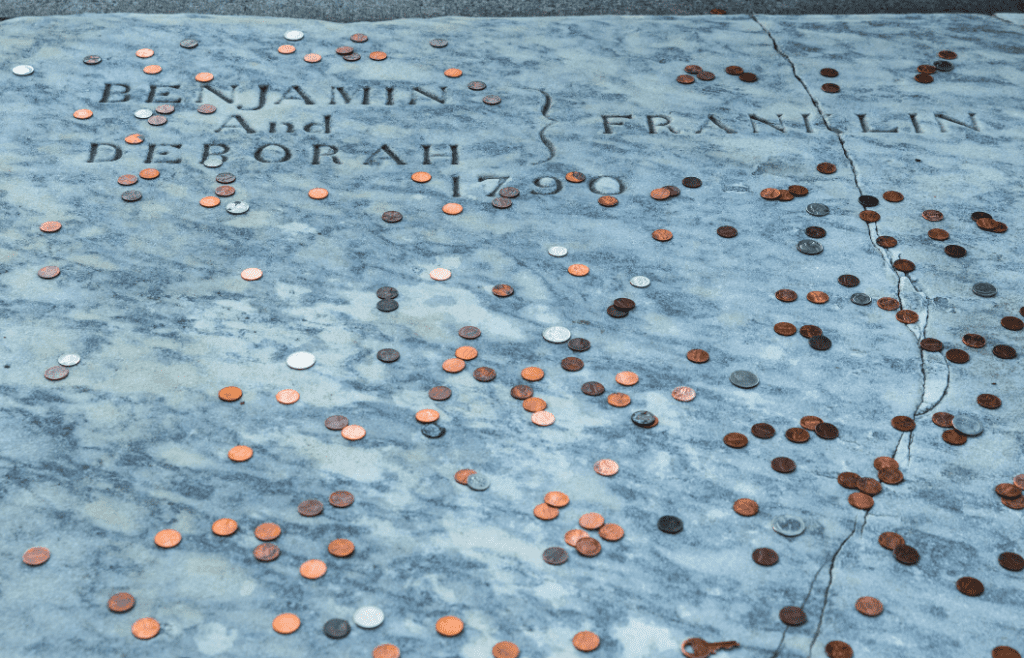 coins scattered on a gravestone