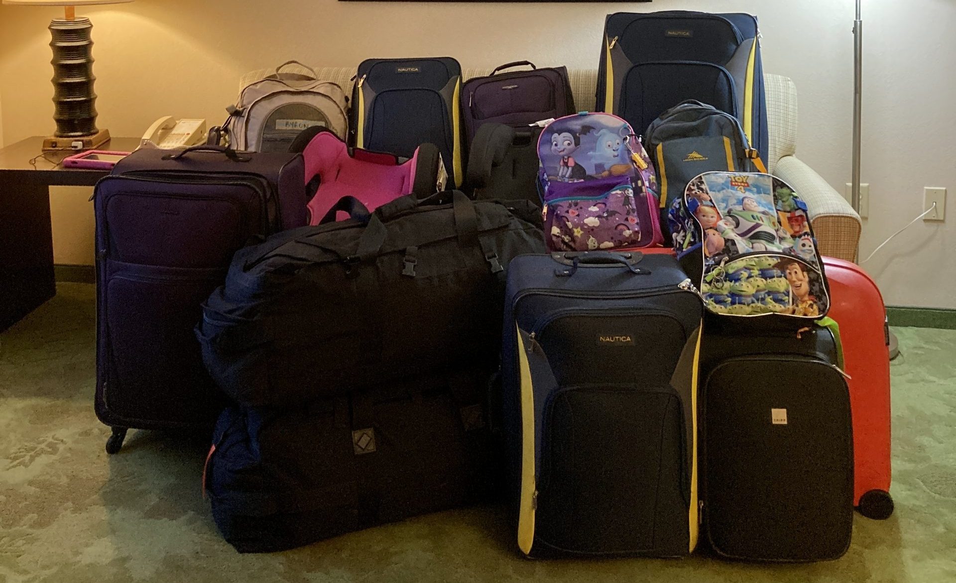13 bags and suitcases are piled together.