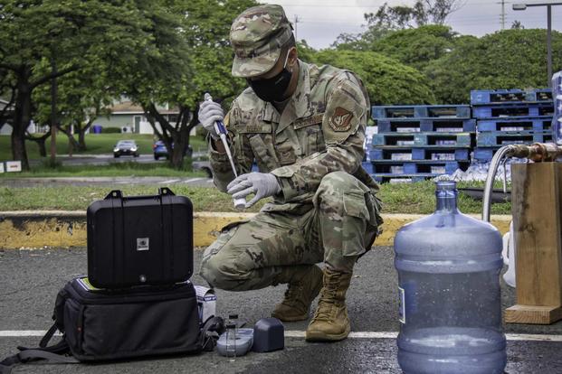 soldier testing water from a large bottle in Hawaii during the 2021 water crisis