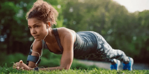 woman exercising outdoors in a plant position