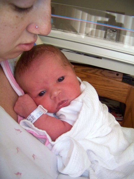 mother holding a newborn baby in the hospital