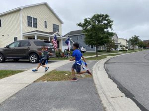 Kids playing a game of flag football in front of their house