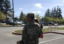 Soldier walking with children in arms