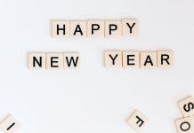 Happy New Year is spelled out in Scrabble tiles.