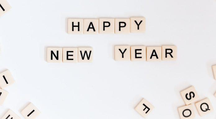 Happy New Year is spelled out in Scrabble tiles.
