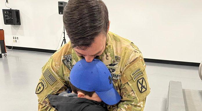 Child saying goodbye to father before deployment